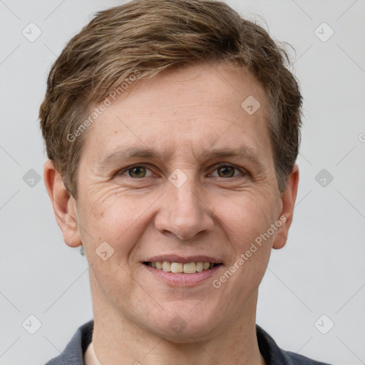 Joyful white adult male with short  brown hair and grey eyes