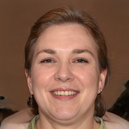 Joyful white adult male with medium  brown hair and brown eyes