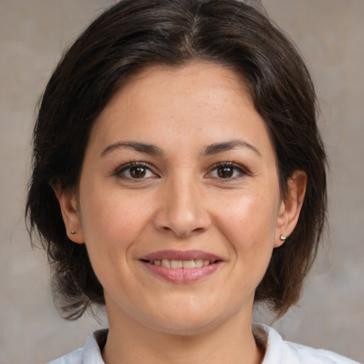 Joyful white adult female with medium  brown hair and brown eyes