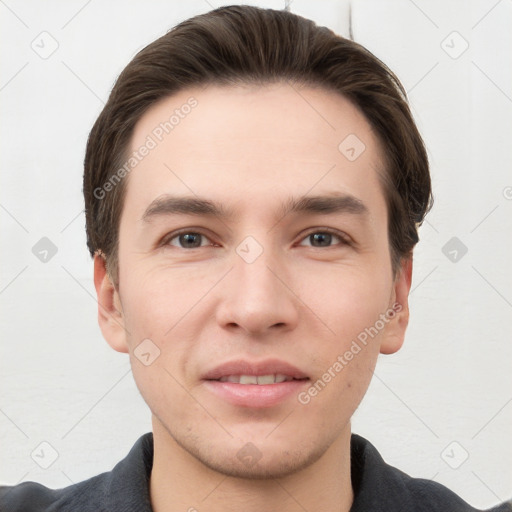 Joyful white young-adult male with short  brown hair and grey eyes