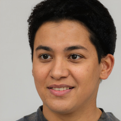 Joyful latino young-adult male with short  brown hair and brown eyes