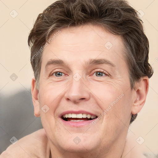 Joyful white adult male with short  brown hair and grey eyes