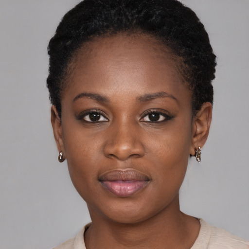 Joyful black young-adult female with short  brown hair and brown eyes