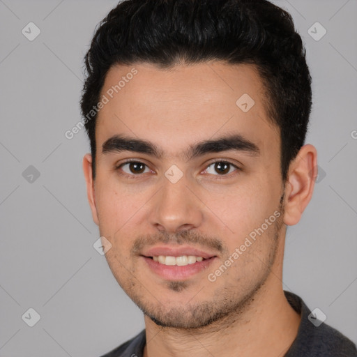 Joyful white young-adult male with short  black hair and brown eyes