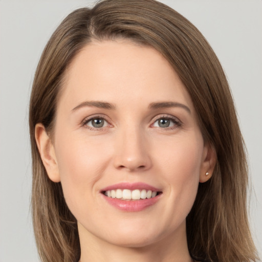 Joyful white young-adult female with long  brown hair and grey eyes