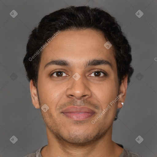 Joyful latino young-adult male with short  brown hair and brown eyes