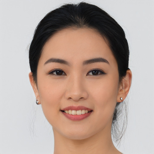 Joyful asian young-adult female with long  black hair and brown eyes