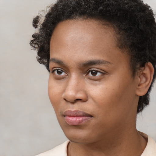 Neutral black young-adult female with short  black hair and brown eyes