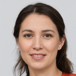 Joyful white young-adult female with medium  brown hair and brown eyes