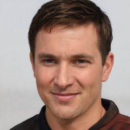 Joyful white adult male with short  brown hair and brown eyes