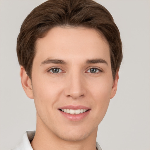 Joyful white young-adult male with short  brown hair and grey eyes