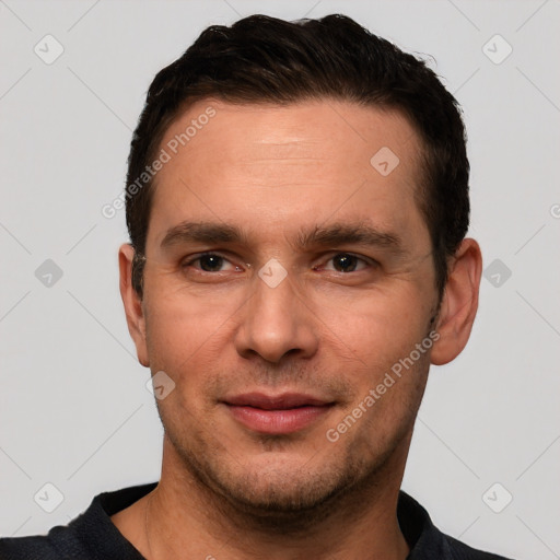 Joyful white young-adult male with short  black hair and brown eyes