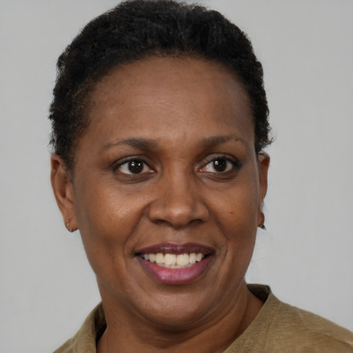 Joyful black adult female with short  brown hair and brown eyes