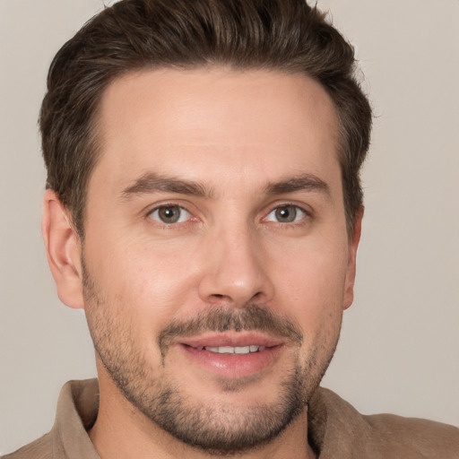 Joyful white young-adult male with short  brown hair and brown eyes