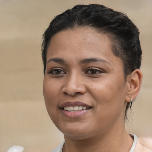Joyful latino young-adult female with short  black hair and brown eyes