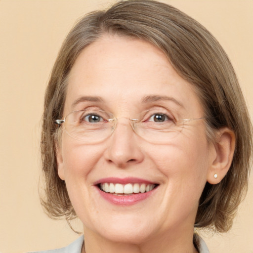 Joyful white adult female with medium  brown hair and grey eyes