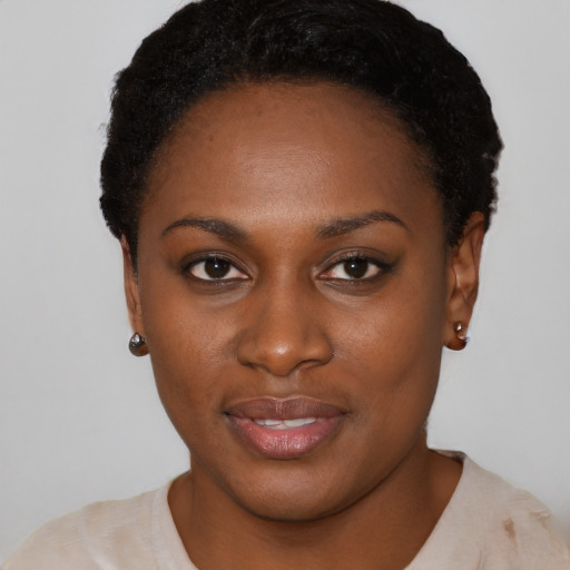 Joyful black young-adult female with short  black hair and brown eyes
