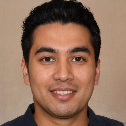 Joyful white young-adult male with short  black hair and brown eyes