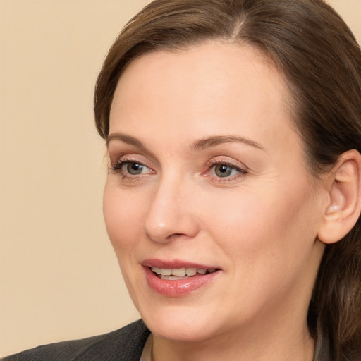 Joyful white adult female with medium  brown hair and brown eyes