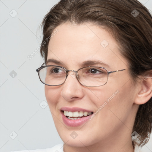 Joyful white adult female with medium  brown hair and grey eyes