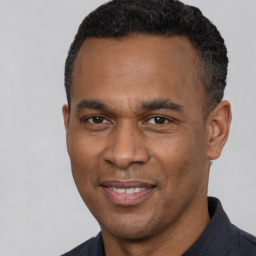 Joyful latino adult male with short  black hair and brown eyes