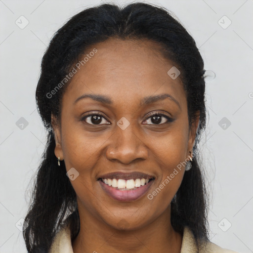 Joyful black young-adult female with long  brown hair and brown eyes