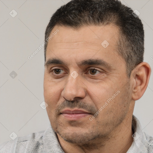 Joyful white adult male with short  black hair and brown eyes