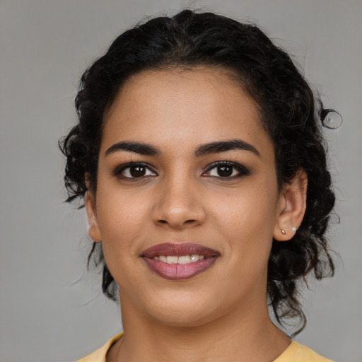 Joyful latino young-adult female with medium  brown hair and brown eyes