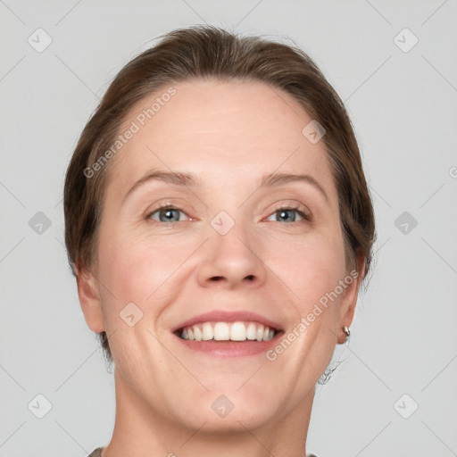 Joyful white adult female with short  brown hair and grey eyes