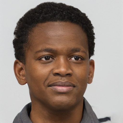 Joyful black young-adult male with short  brown hair and brown eyes