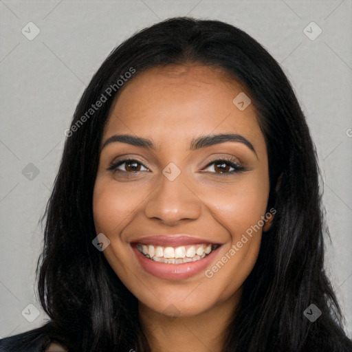 Joyful latino young-adult female with long  black hair and brown eyes