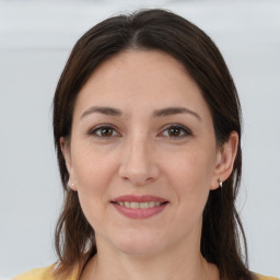 Joyful white young-adult female with medium  brown hair and brown eyes