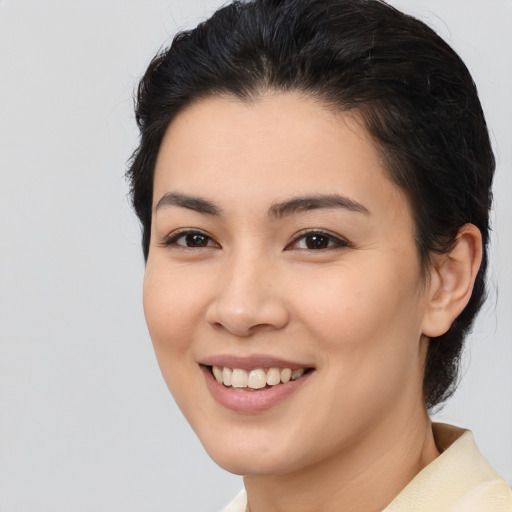 Joyful white young-adult female with medium  black hair and brown eyes