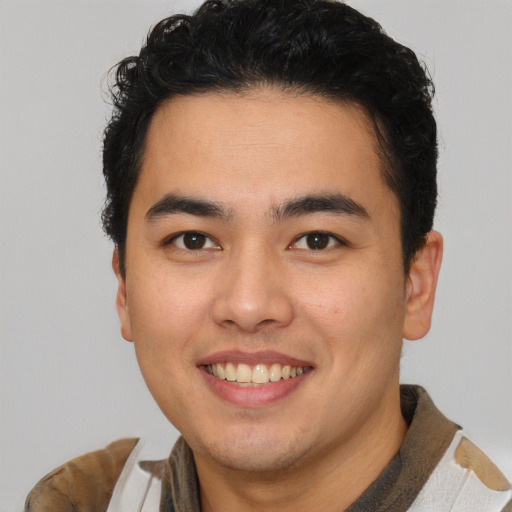 Joyful latino young-adult male with short  brown hair and brown eyes
