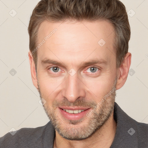 Joyful white adult male with short  brown hair and brown eyes