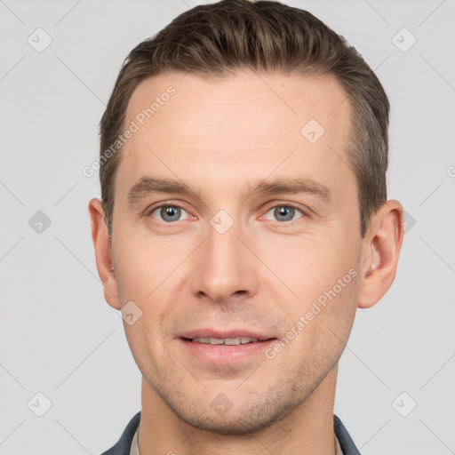 Joyful white young-adult male with short  brown hair and grey eyes