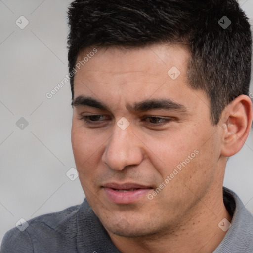 Joyful white young-adult male with short  black hair and brown eyes