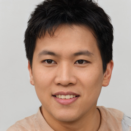 Joyful asian young-adult male with short  brown hair and brown eyes