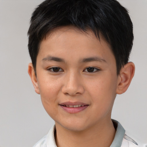 Joyful white child male with short  brown hair and brown eyes