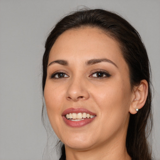 Joyful white young-adult female with long  brown hair and brown eyes