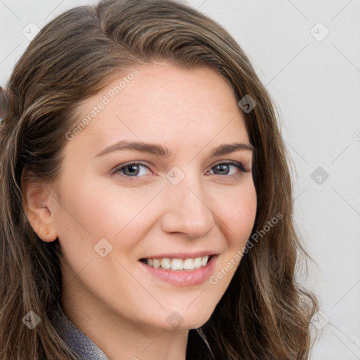 Joyful white young-adult female with long  brown hair and blue eyes