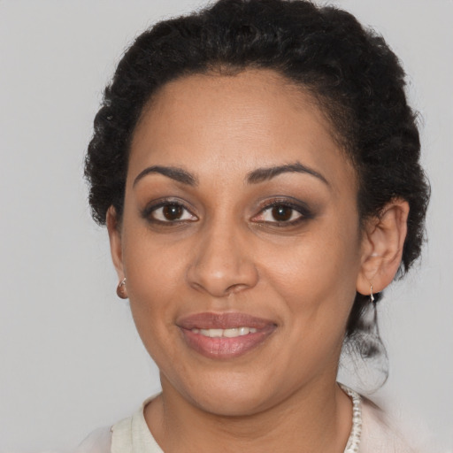 Joyful black young-adult female with short  brown hair and brown eyes