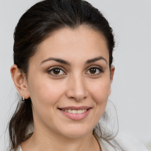 Joyful white young-adult female with medium  brown hair and brown eyes