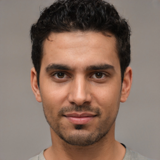 Joyful white young-adult male with short  black hair and brown eyes