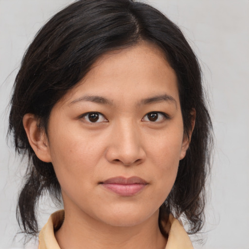 Joyful asian young-adult female with medium  brown hair and brown eyes