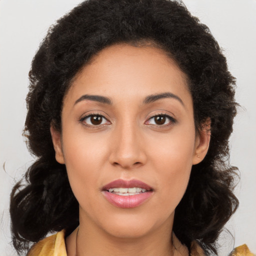 Joyful latino young-adult female with long  brown hair and brown eyes