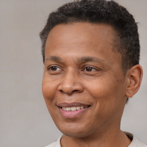 Joyful latino adult male with short  brown hair and brown eyes