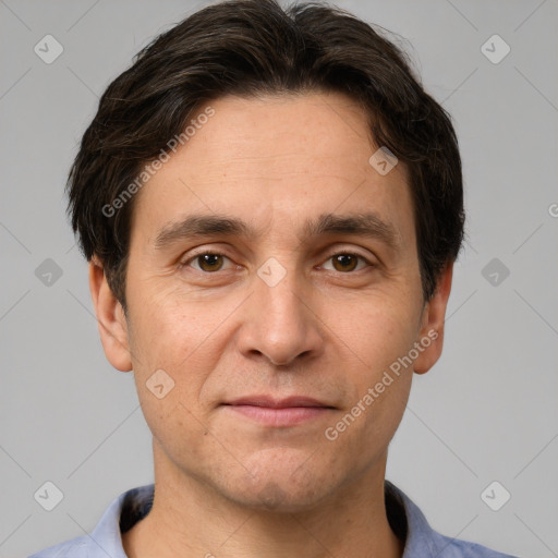 Joyful white adult male with short  brown hair and brown eyes