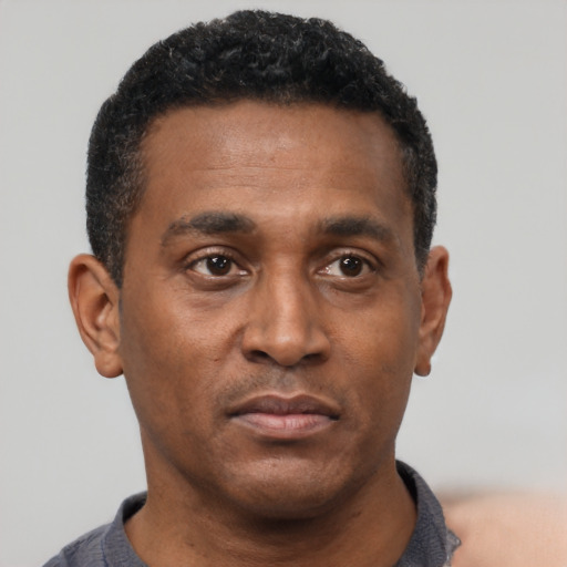 Neutral black young-adult male with short  black hair and brown eyes