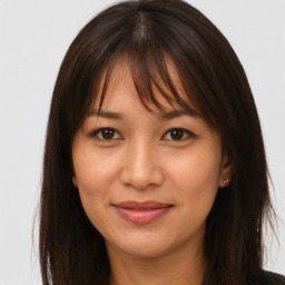 Joyful asian young-adult female with long  brown hair and brown eyes